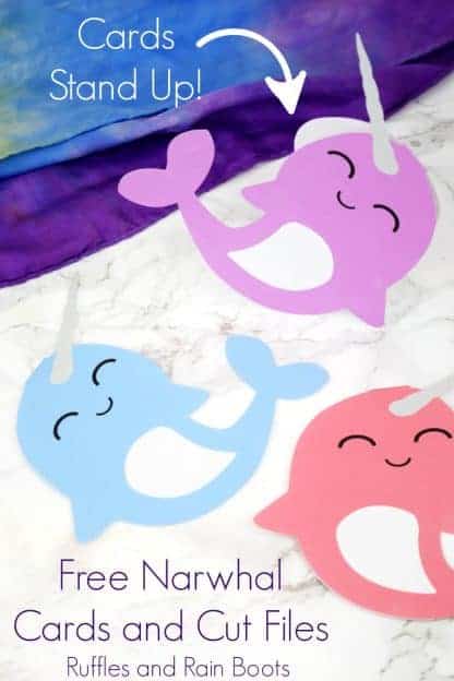 pink blue and purple kawaii narwhal cards on white marble background with rainbow silk scarf and text which reads free narwhal cards and cut files