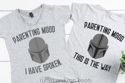 two gray t shirts on a white wood background with free Mandalorian SVG with helmet and parenting moods