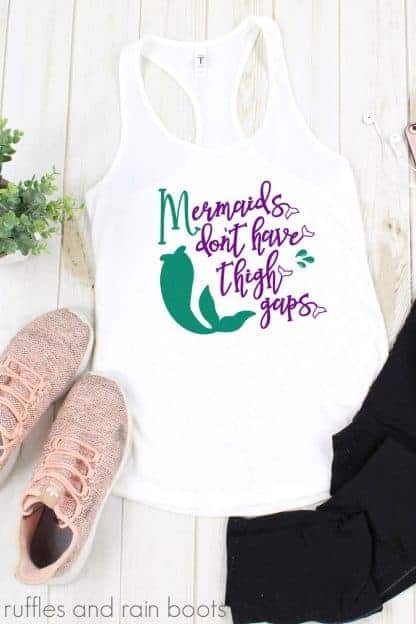 mermaid workout svg in teal and purple vinyl on white tank on white background with water bottle and tennis shoes