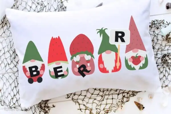 sublimation strawberry gnome designs on a pillow laying on a table
