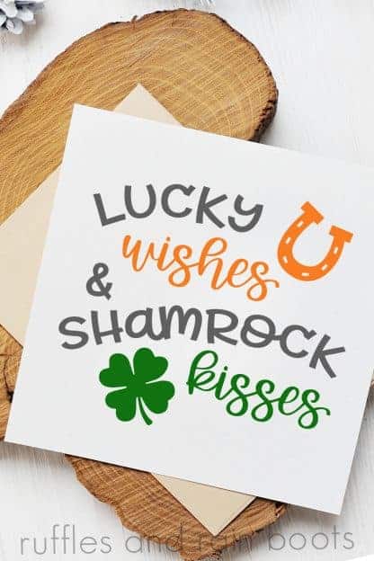 vertical image of a close up st patrick's day card with lucky wishes and shamrock kisses cut file