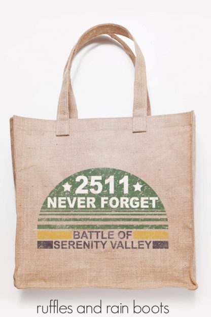 jute tote bag in natural color on white background with distressed svg file never forget battle of serenity added in vinyl using Cricut machine