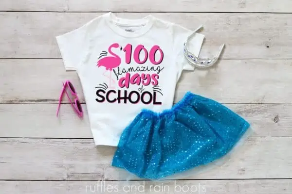 kids shirt laying on a table featuring a 100 days of school idea flamingo flamazing days of school svg