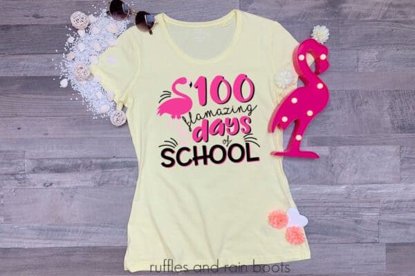 teacher shirt laying on a table featuring a 100 flamazing days of school flamingo svg