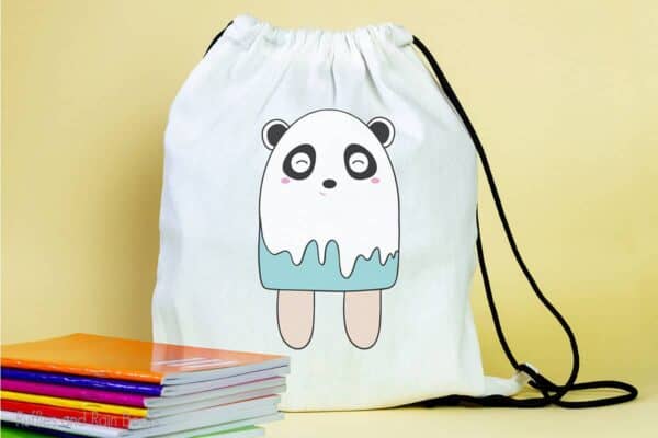 backpack featuring a popsicle Panda SVG For cutting machines sitting on a table with notebooks
