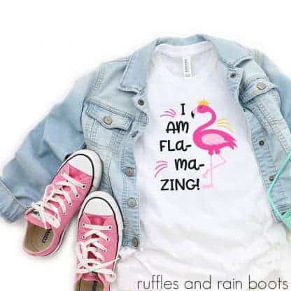kids t-shirt laying on a table with accessories featuring a fun flamingo motivational svg for kids flamazing