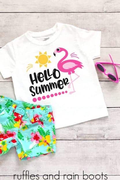 hello summer flamingo svg for cricut silhouette on a kids shirt laying on a table with floral shorts