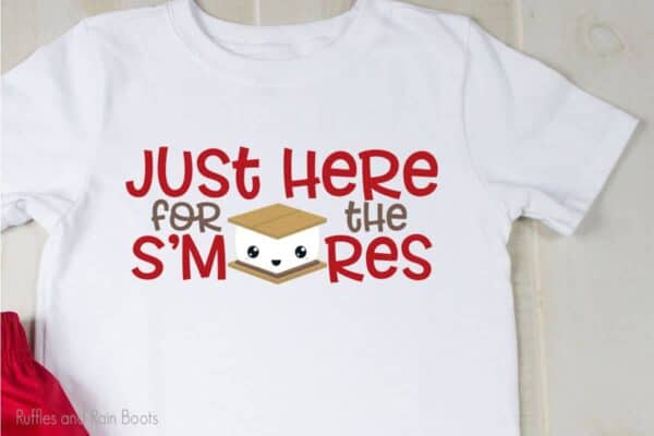 t-shirt laying on a table with Just Here for the Smores cut file for cricut or silhouette on the shirt