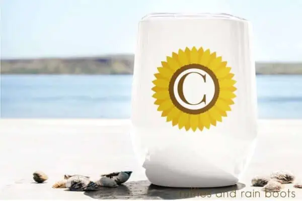 stemless wine glass tumbler sitting on the beach featuring a Sunflower Monogram sublimation file