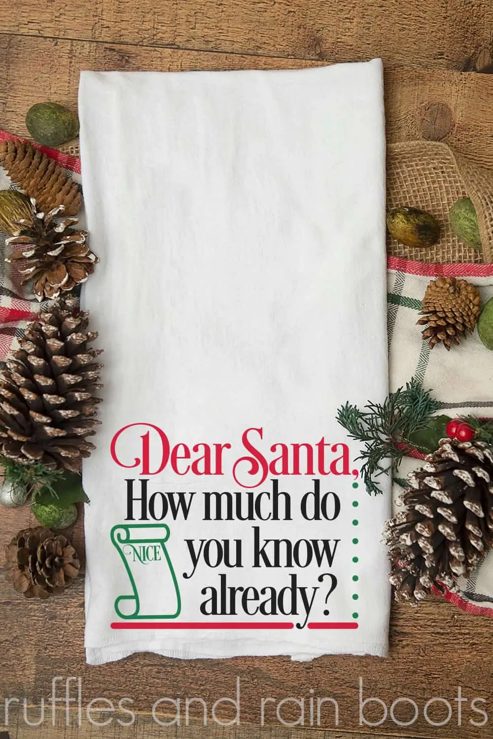 vertical image of white towel on wood background with Dear Santa svg in red black and green