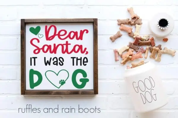 horizontal image featuring dog treats and a white frame on white background with a Christmas svg of Dear Santa it was the dog in red green and black
