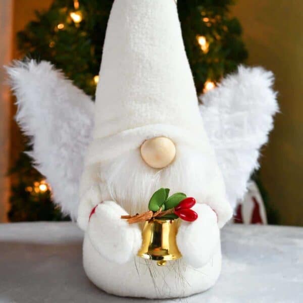 Close up of a white angel gnome holding a holiday bell made with the Scandinavian Sweeties gnome pattern and free angel wing pattern.