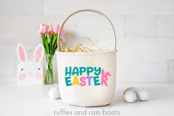 holiday scene on white wood with colorful happy Easter in vinyl on canvas Easter basket