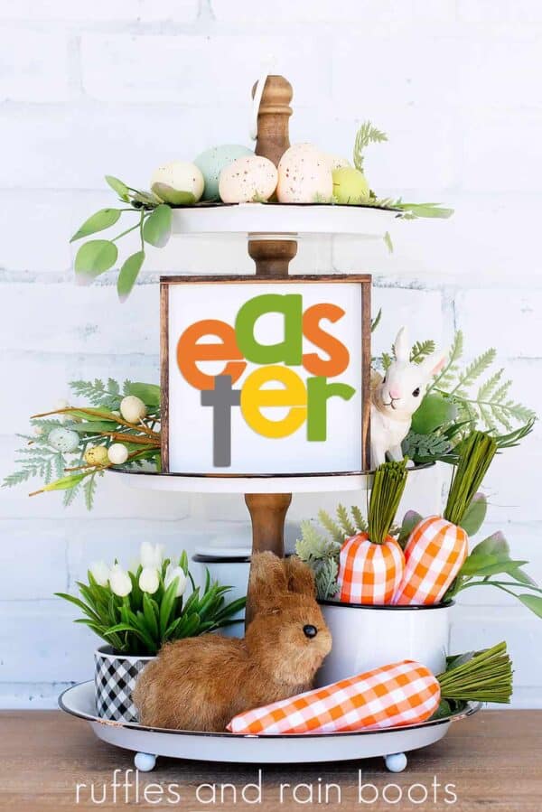 bright vertical image of tiered tray with carrots, greenery, bunny, and Easter SVG with cross on square sign