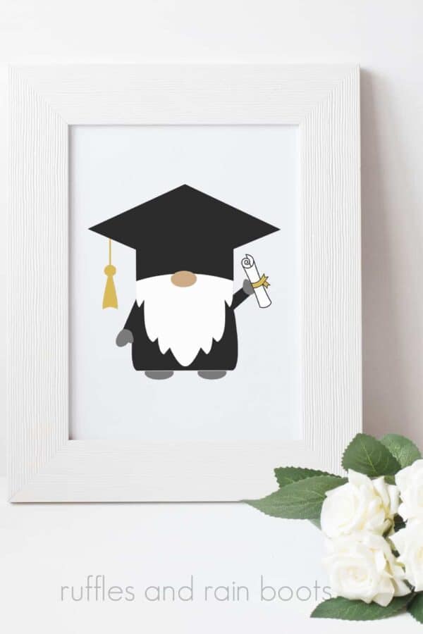 graduation gnome in white frame on white background with white roses