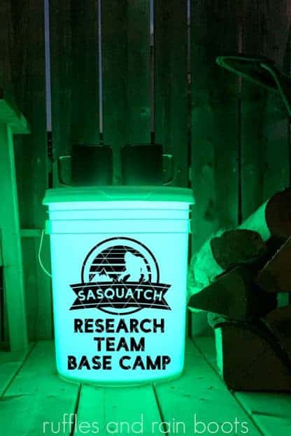 light green camp bucket svg in black vinyl which says sasquatch research team base camp
