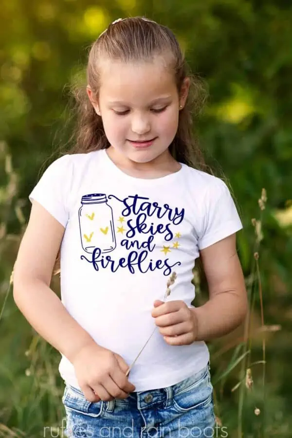 child wearing a shirt featuring a Summer SVG Starry Skies Fireflies
