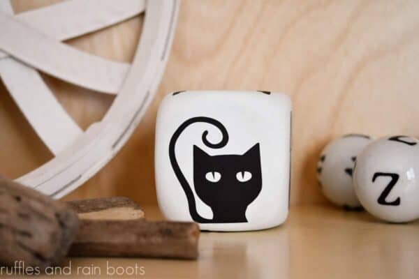 free black cat svg for halloween from ruffles and rain boots on a painted dollar tree foam dice for a story cube