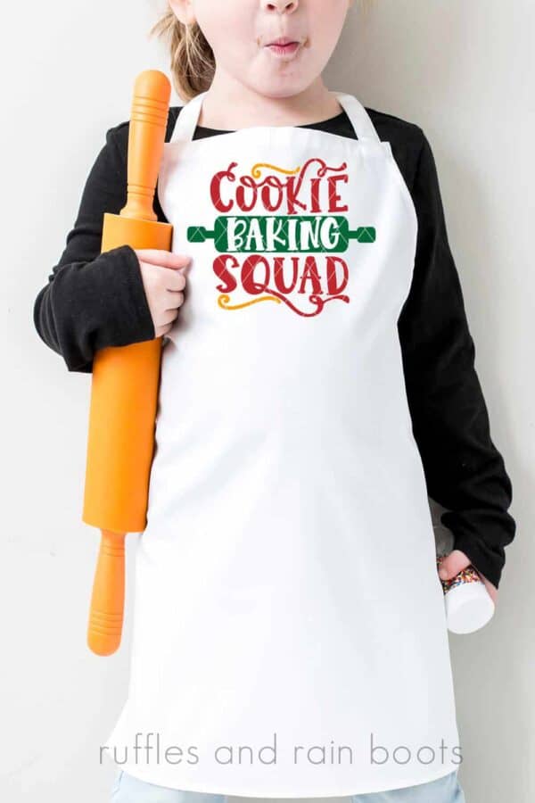 little girl with an apron featuring Cookie Baking Squad Christmas SVG for cricut or silhoutte