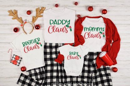 horizontal image of family Christmas pajama set on white wood background with holiday accessories and Christmas Claus SVG in green and red vinyl