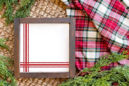 horizontal image of flour sack SVG in red on dark wood frame with canvas on a holiday background