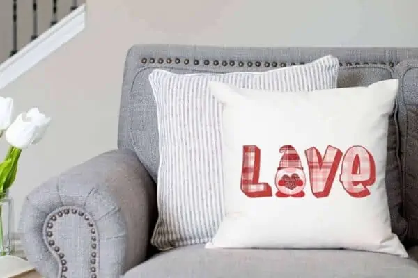 horizontal image close up of a white pillow with a plaid love gnome sublimation print from ruffles and rain boots