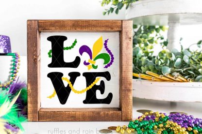 LOVE mardi gras SVG on white tiered tray sign in black purple green and yellow vinyl from ruffles and rain boots.