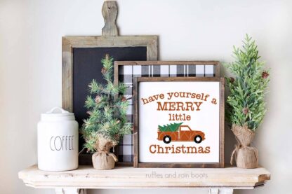 Horizontal image of have yourself a merry little Christmas truck SVG on white frame on farmhouse mantle.