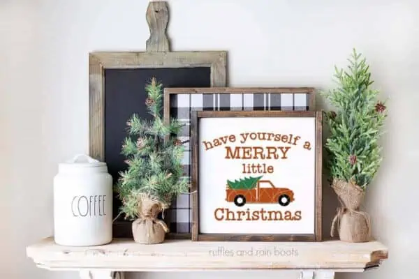 Horizontal image of have yourself a merry little Christmas truck SVG on white frame on farmhouse mantle.