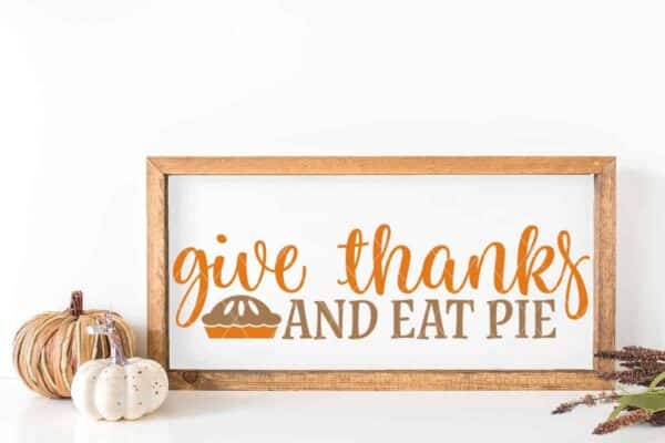 Horizontal sign on white background which reads give thanks and eat pie.