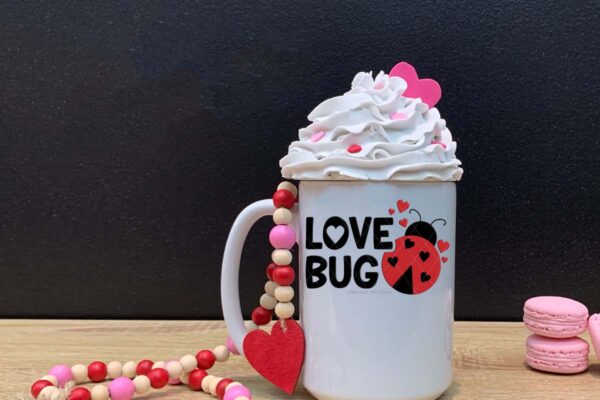 Horizontal image of love bug svg in black and red vinyl on faux Valentine mug.