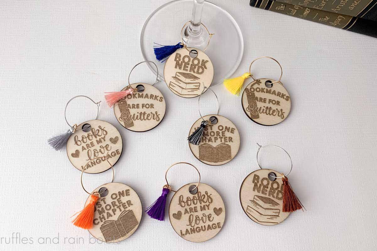 Horizontal image of eight wood wine charms made with xTool m1 laser cutter and engraver.