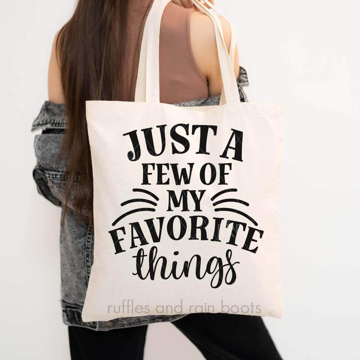 Vertical image of woman holding a natural tote bag which reads just a few of my favorite thing from Ruffles and Rain Boots.