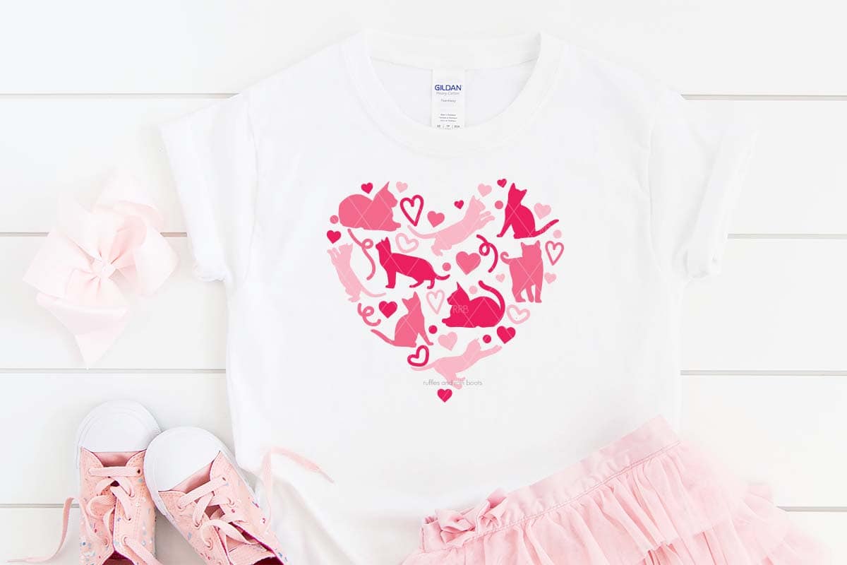 Horizontal image of a pink skirt and shoes with a white shirt with a multi pink shade of cart heart SVG made with Cricut.