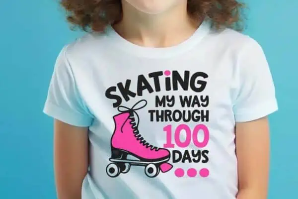 Horizontal image of little girl against a blue background wearing a white shirt which reads skating my through 100 days with a pink roller skate.