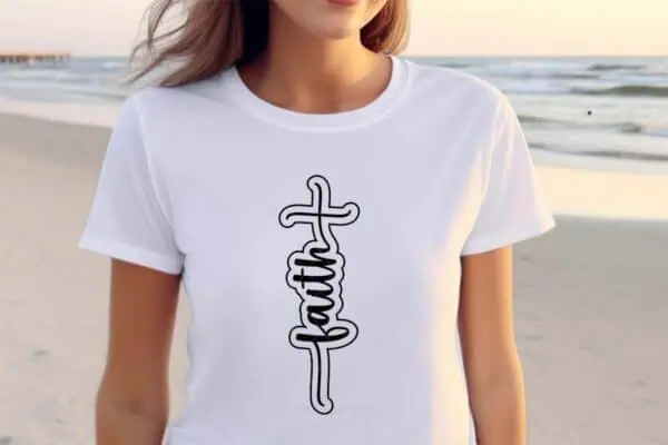 Horizontal image of a beach with a woman in a white t-shirt made with a Free faith SVG with cross and offset styling from Ruffles and Rain Boots SVG free.