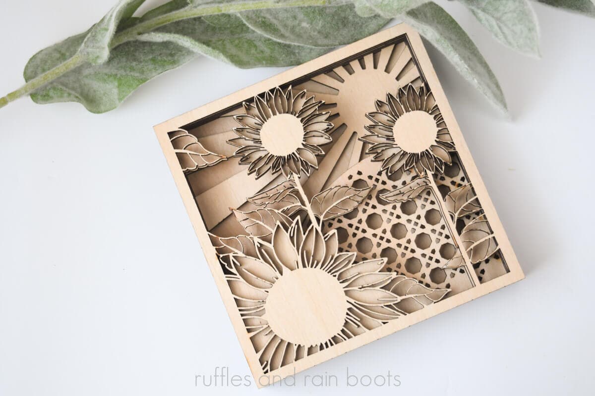 Horizontal image of a natural wood sunflower shelf sitter SVG made into a sign.