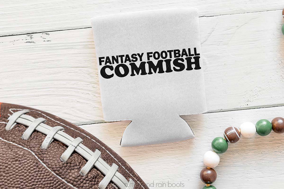 Horizontal image of a football, some beards, and a can cooler which reads fantasy football commish.