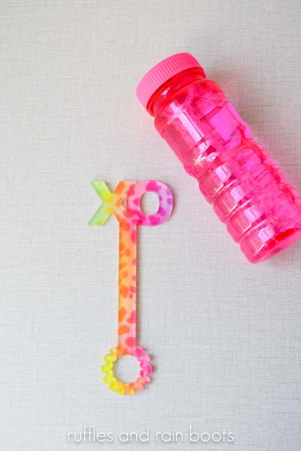 XO bubble wand for Valentine's Day with a pink jar of bubbles.
