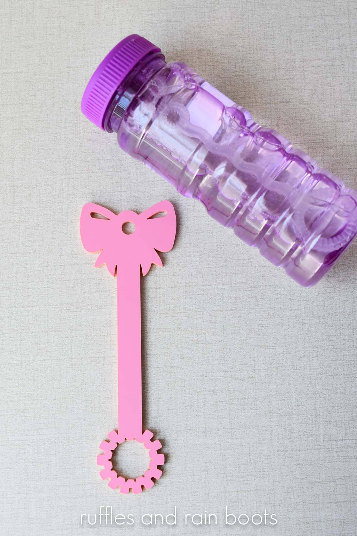 Bow bubble wand for Valentine's Day with a purple jar of bubbles.