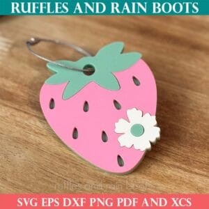 Strawberry bag tag in pink, green, and bone acrylic with wire hanger from Ruffles and Rain Boots laser cut SVG.