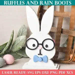 Square close up image of a laser cut Easter bunny shelf sitter, two sided boy and girl bunny on holiday background.